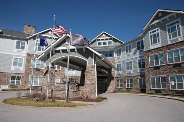 Exterior view of assisted living facility with flags