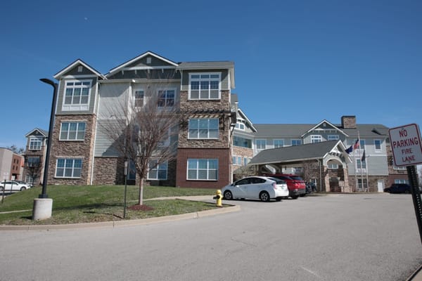 Exterior view of a senior living facility with parking