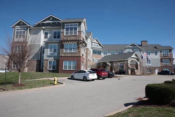 Exterior view of a senior living facility with parking