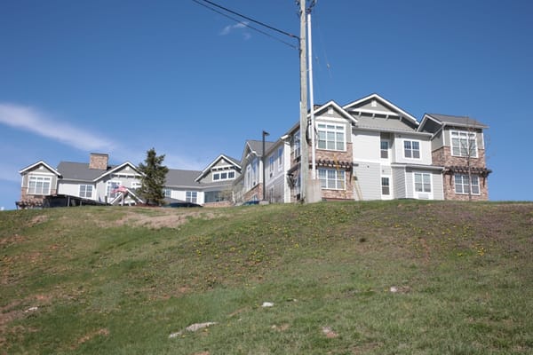 Exterior view of a senior living facility on a hillside