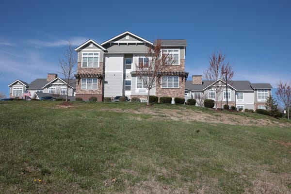 Exterior view of a senior living facility with landscaped grounds
