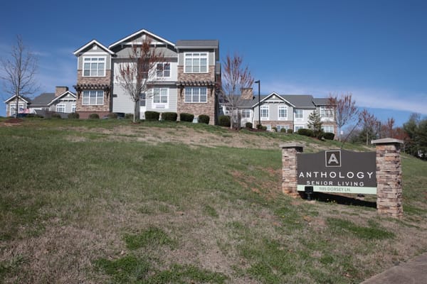 Exterior view of a senior living facility with signage