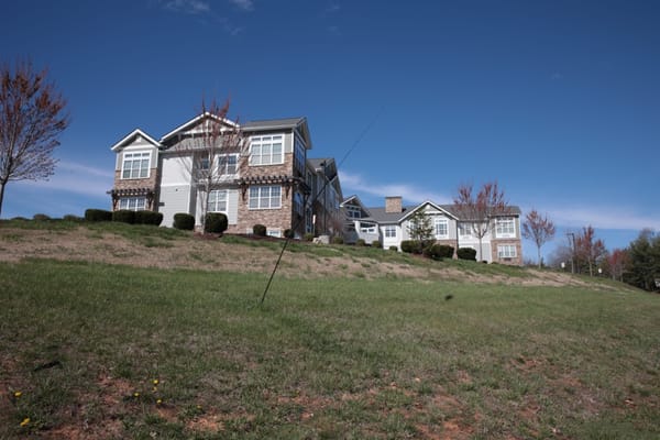 Exterior view of a senior living facility with landscaping