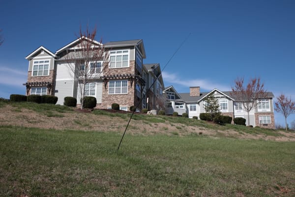 Exterior view of a senior living facility against a blue sky