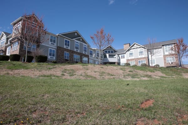 Exterior view of a senior living facility with landscaping