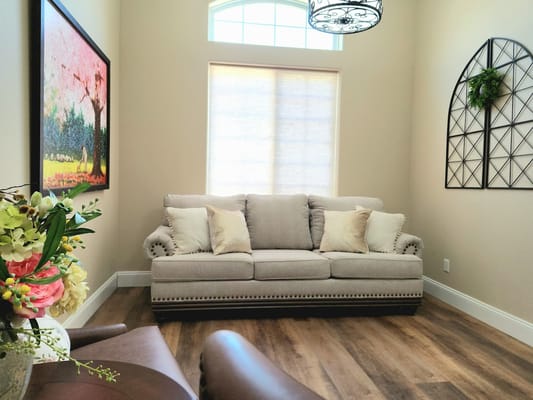 Cozy interior lounge area with a sofa and artwork