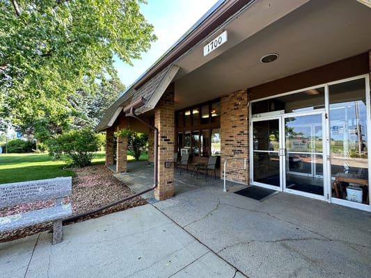 Entrance of a senior living facility with outdoor seating