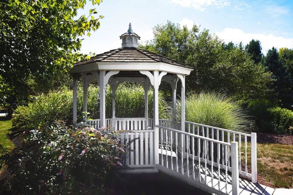 A gazebo surrounded by lush greenery in a garden
