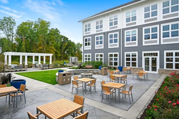 Outdoor seating area with tables and landscaping