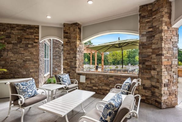 Cozy outdoor seating area with stone walls