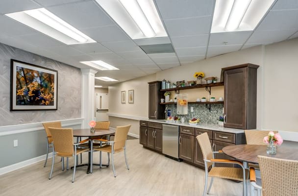 Interior view of a dining area with tables and kitchenette
