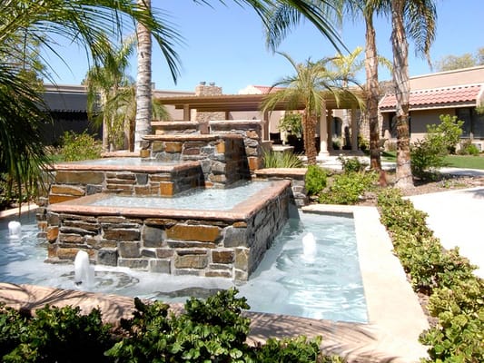 Beautiful outdoor fountain surrounded by lush landscaping