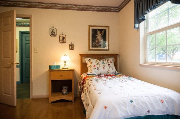 Cozy private room with a bed and window view