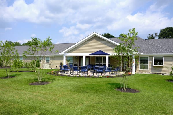 Exterior view of a senior living facility with a patio area