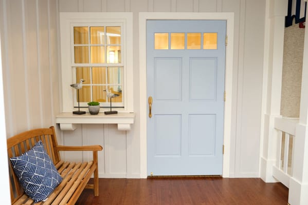 Cozy interior hallway with blue door and bench