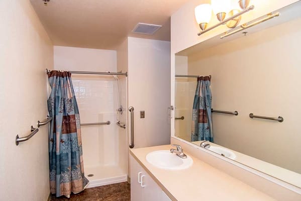 Bright and clean bathroom with shower and sink