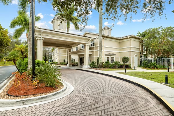 Entrance of a senior living facility with gardens