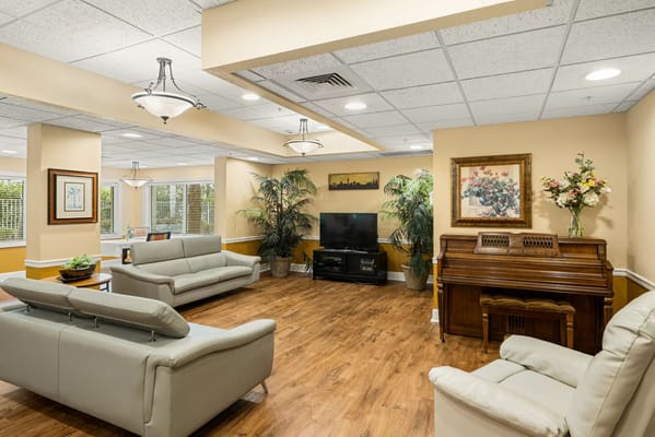 Common area with seating and decor in a senior living facility