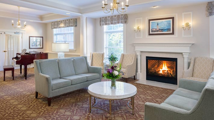 Bright common area with seating and a fireplace