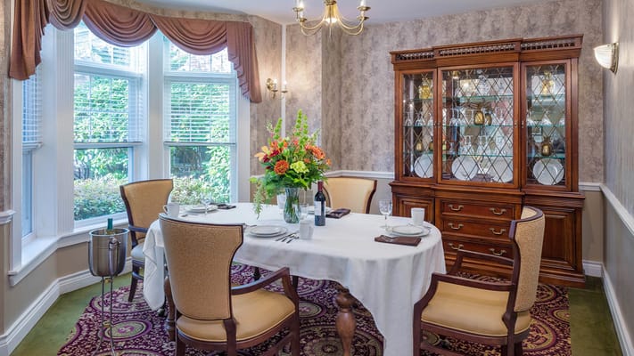 Dining room set with flowers and table setting
