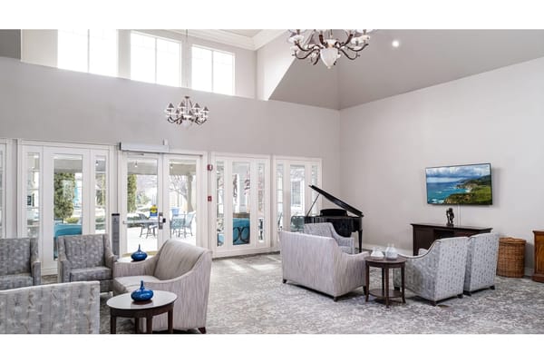 Lounge area with seating and a grand piano
