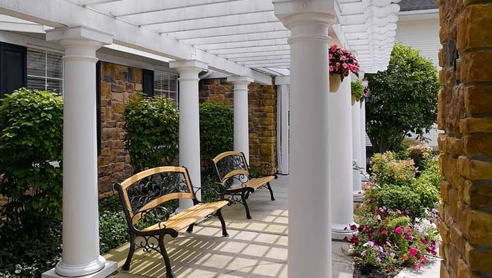 Outdoor seating area with flowers and greenery