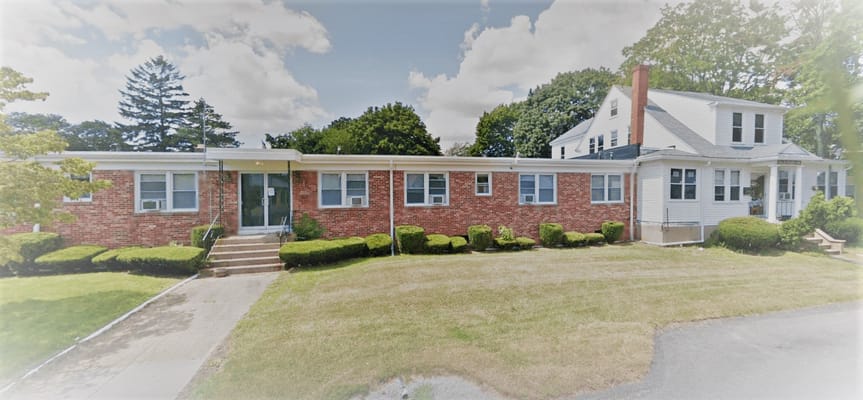 Exterior view of a senior living facility with landscaping