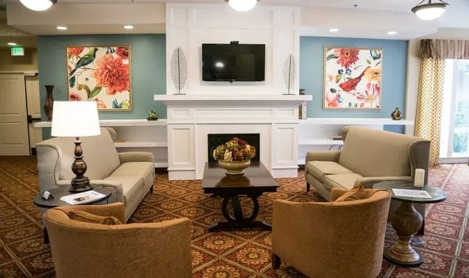 Living room with comfortable seating and floral artwork