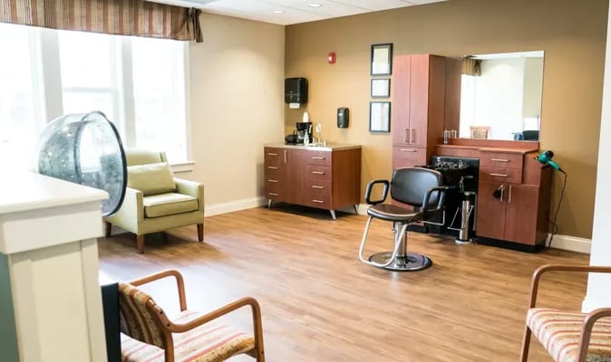 Interior view of the hair salon with styling chair and storage cabinets