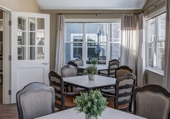 Bright, inviting common area with tables and chairs