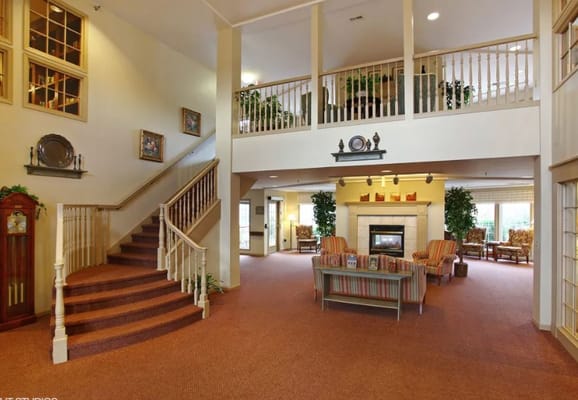 Bright common area with seating and staircase