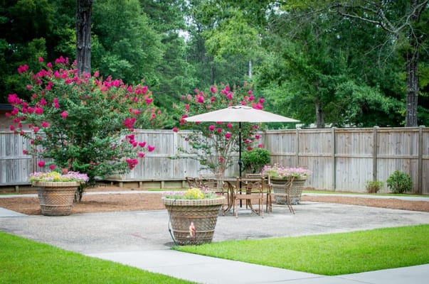 Outdoor patio area with flowers and seating