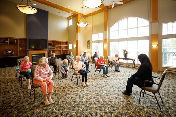 Residents participating in a seated activity in a common area