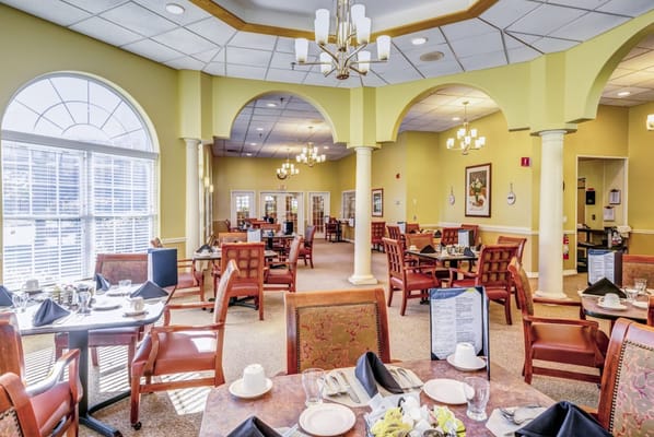 Interior view of the dining room with tables set for meals