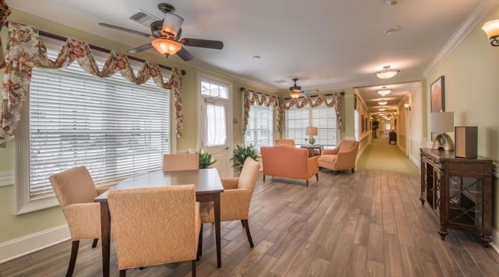 Brightly lit common area with seating and dining table