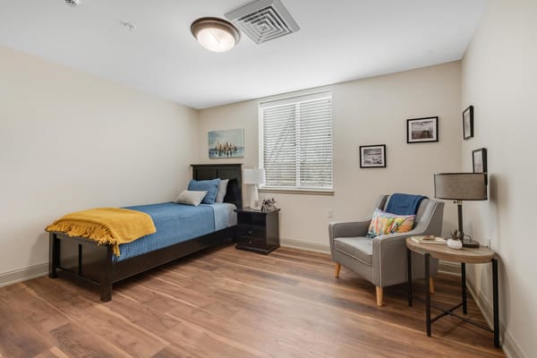 Cozy resident room with bed and sitting area