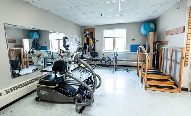 Therapy gym with exercise equipment and stairs