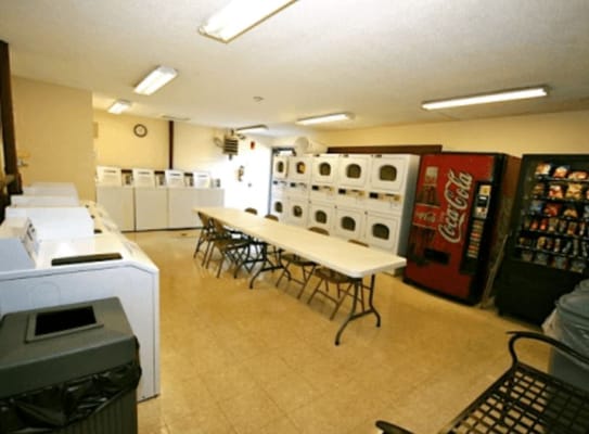 Interior view of the laundry room with washing machines and vending machines