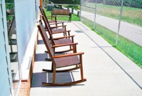 Row of rocking chairs on a sunny patio