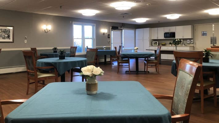 Dining area with tables and chairs set up for residents