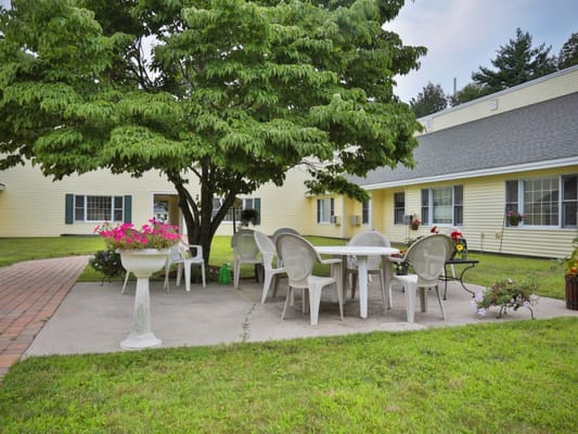 Outdoor seating area with tables under a tree