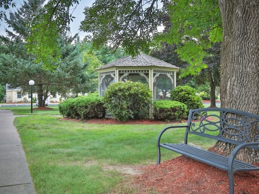 Outdoor gazebo surrounded by landscaped gardens