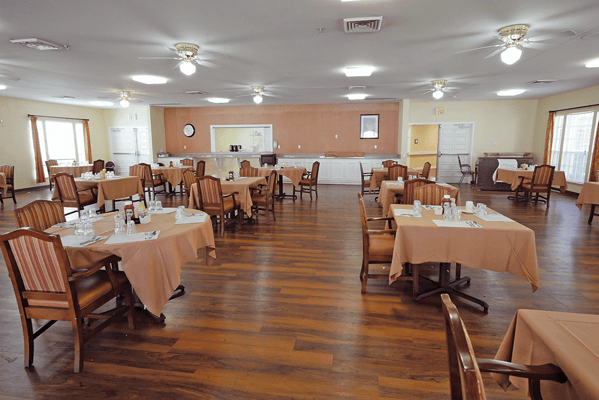 Dining area with tables set for residents