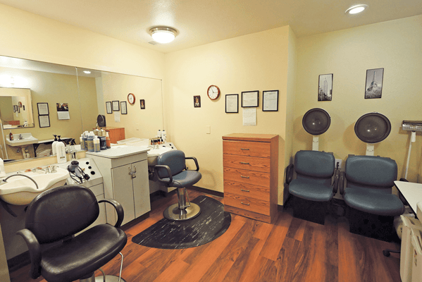 Interior view of a salon area with chairs and equipment