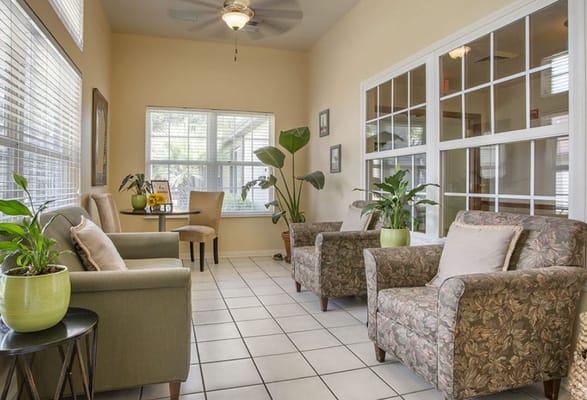 A cozy common area with comfortable seating and plants