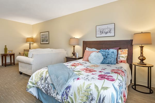 Cozy bedroom setup with floral bedding and warm lighting