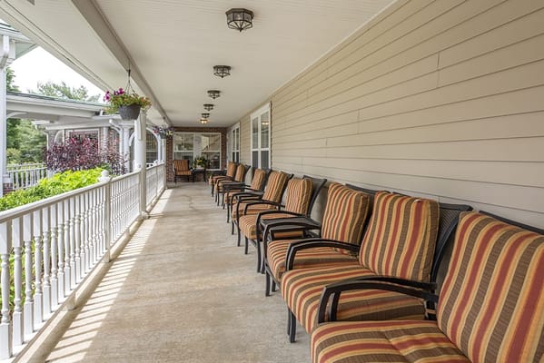 Outdoor seating area with striped chairs on a porch