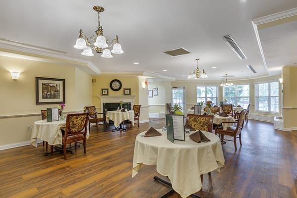 Bright dining room with tables set for meals
