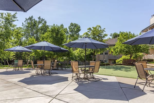 Patio area with umbrellas and seating in a garden