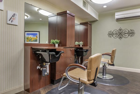 Beauty salon area with styling chairs and mirrors